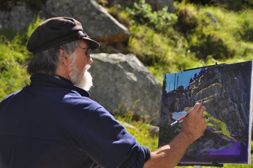 Mark Hobson painting a rocky landscape.